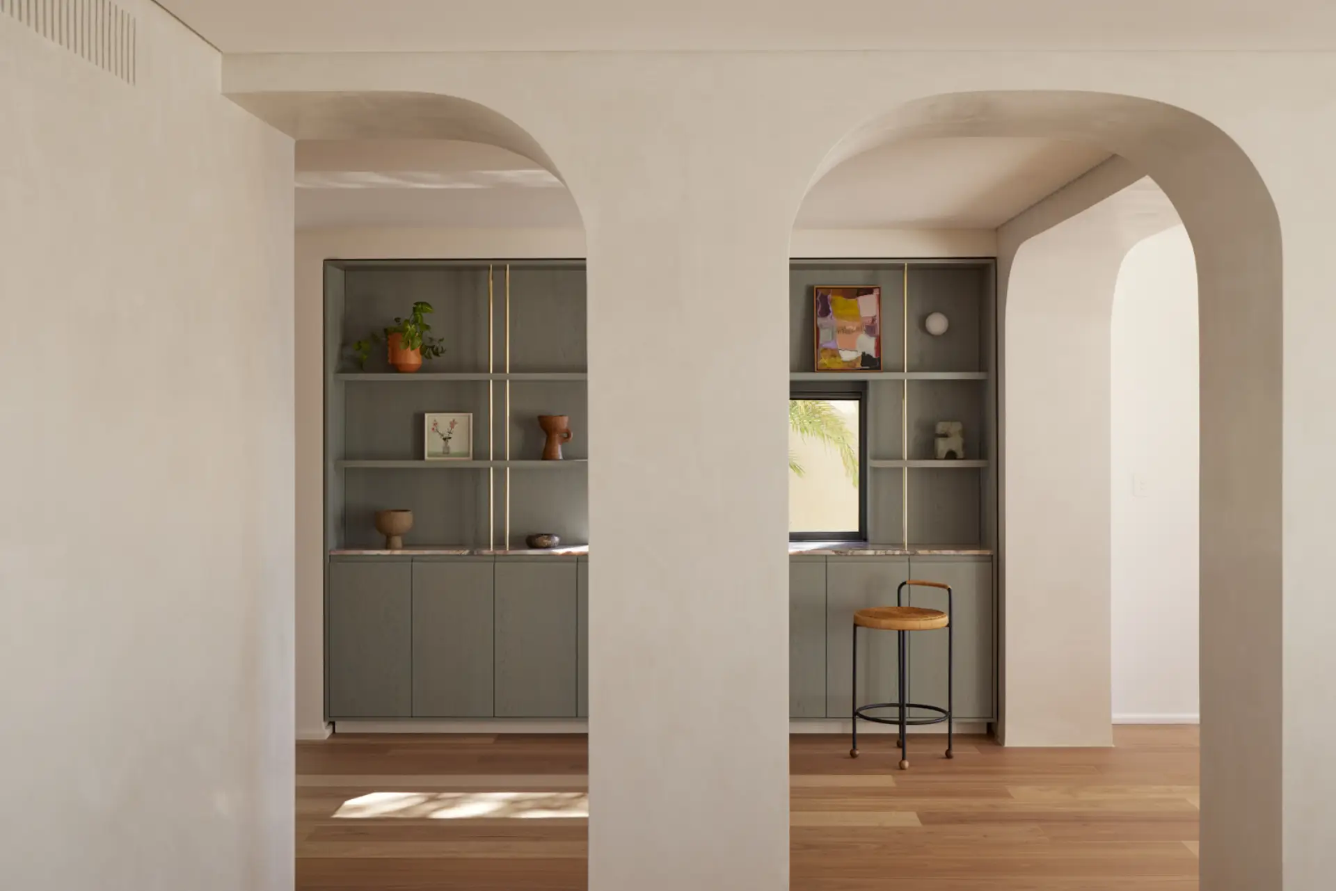 Architectural interior with arched doorways and custom joinery